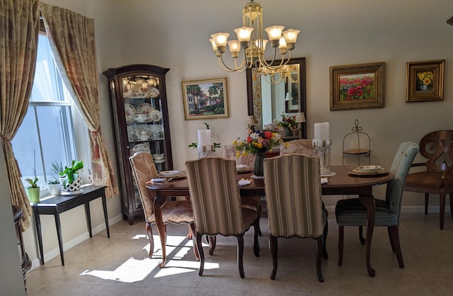 dining room featuring light tile patterned floors, baseboards, and an inviting chandelier