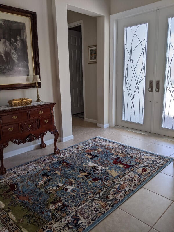 entrance foyer with baseboards and light tile patterned floors