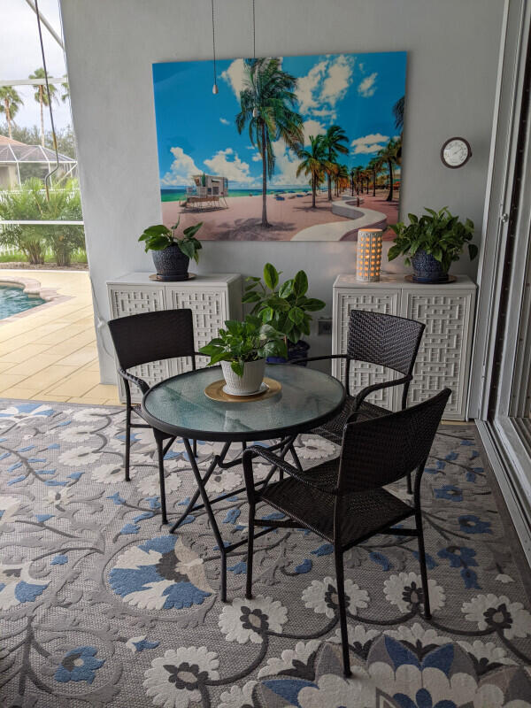 view of patio featuring a lanai