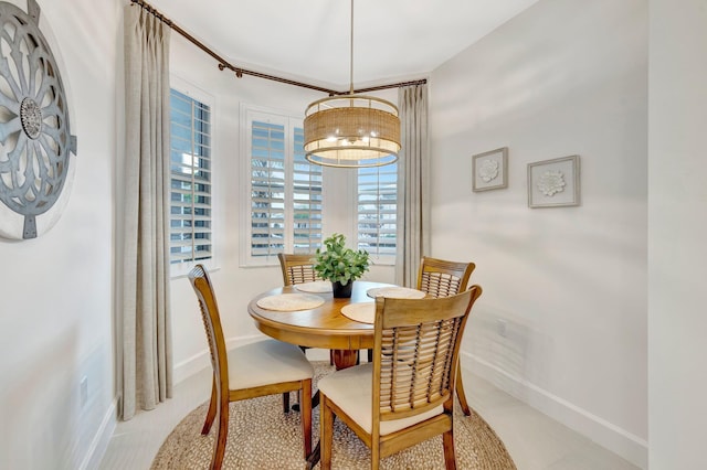 dining area featuring baseboards and a chandelier