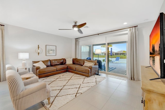 living room featuring a ceiling fan, recessed lighting, and light tile patterned floors