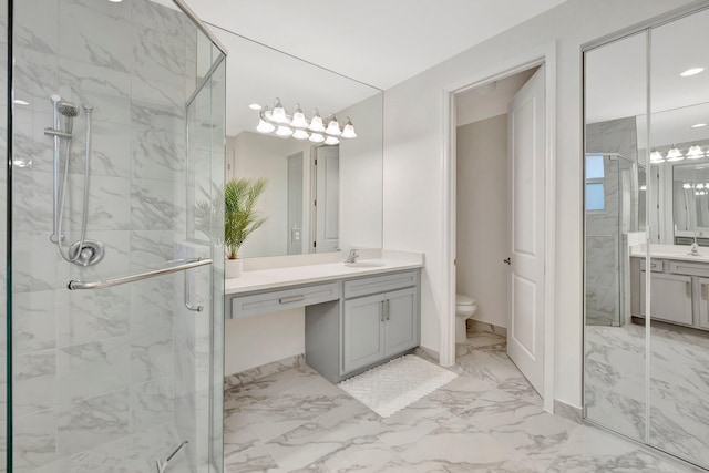 bathroom with marble finish floor, toilet, vanity, and a marble finish shower