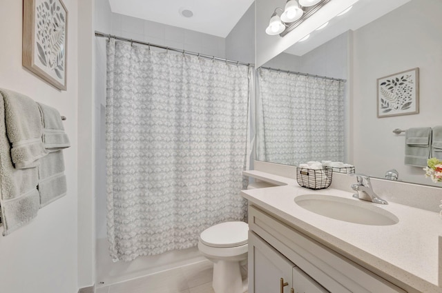 bathroom with vanity, toilet, and tile patterned floors