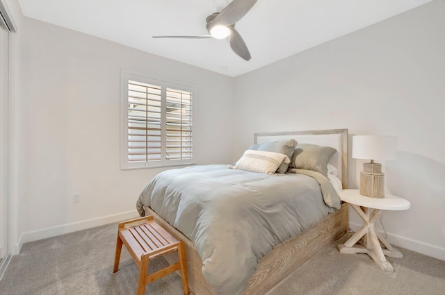 bedroom with light carpet, baseboards, and a ceiling fan