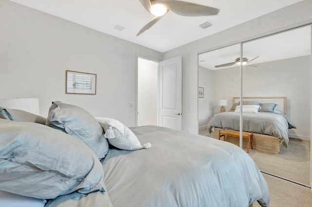 bedroom featuring baseboards, visible vents, a ceiling fan, carpet floors, and a closet