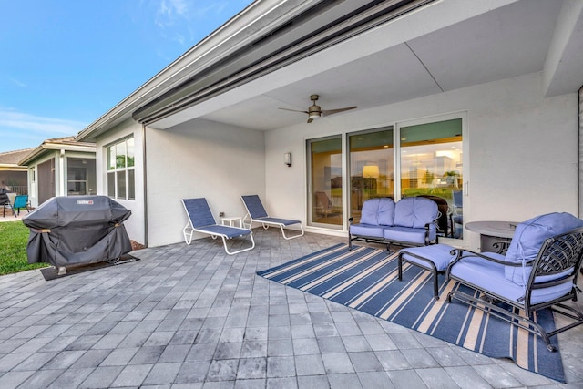 view of patio / terrace featuring a grill, an outdoor living space, and a ceiling fan