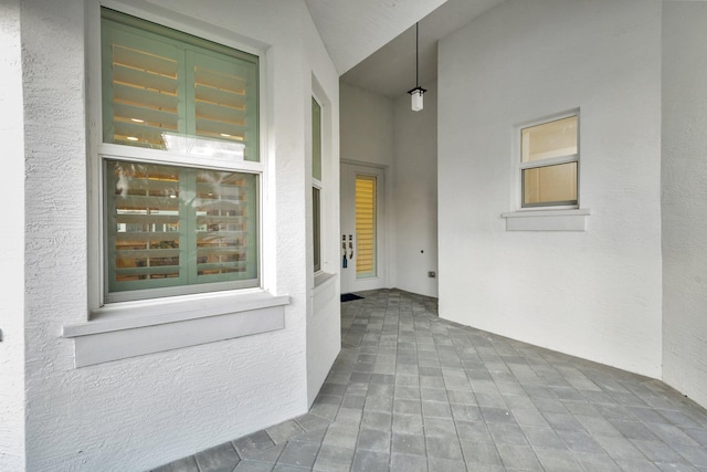 property entrance with a patio and stucco siding