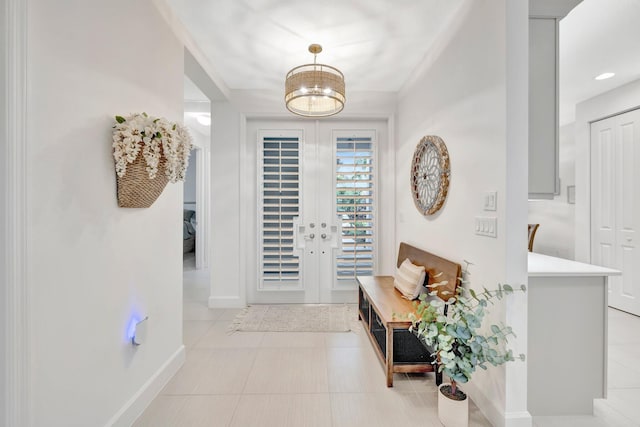 entryway with french doors, baseboards, and light tile patterned floors