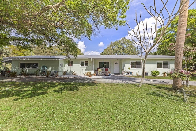 rear view of property with a porch and a lawn