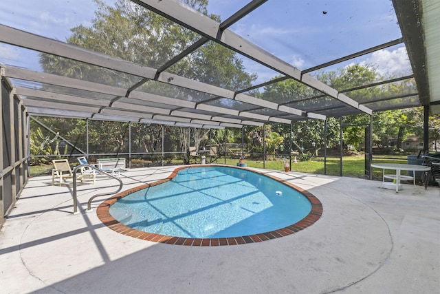 pool featuring a patio, a yard, and a lanai