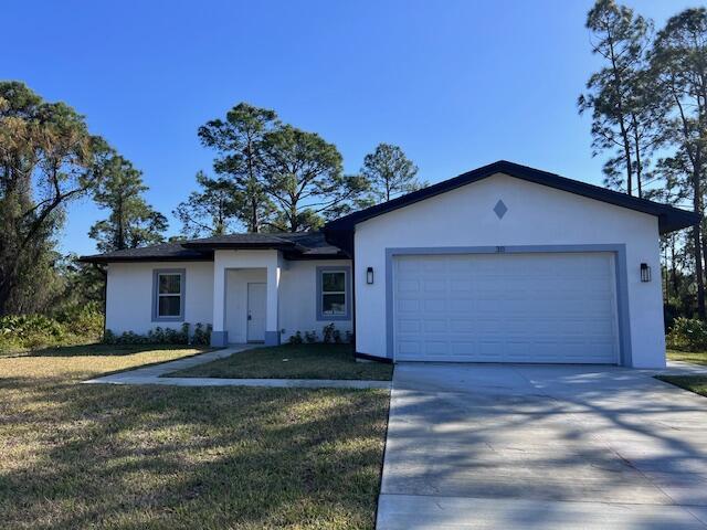 ranch-style house featuring an attached garage, a front lawn, concrete driveway, and stucco siding