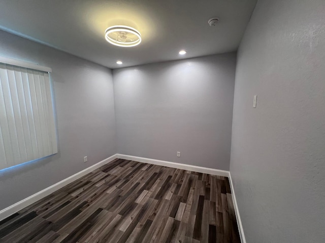 unfurnished room with dark wood-style floors, recessed lighting, and baseboards