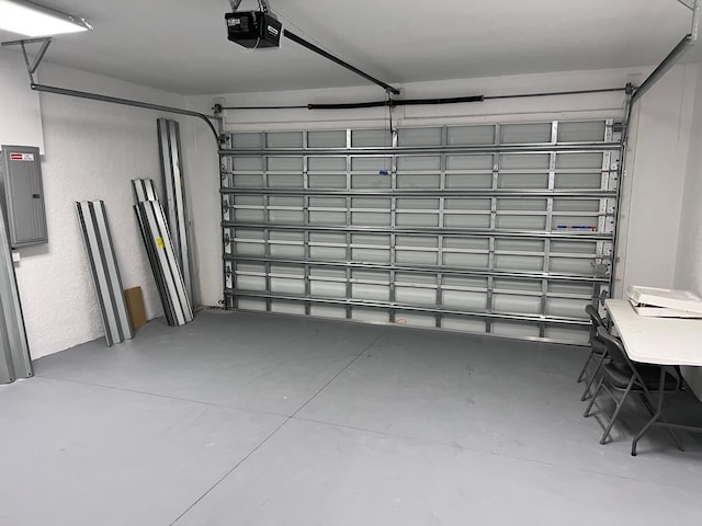 garage with electric panel and a garage door opener