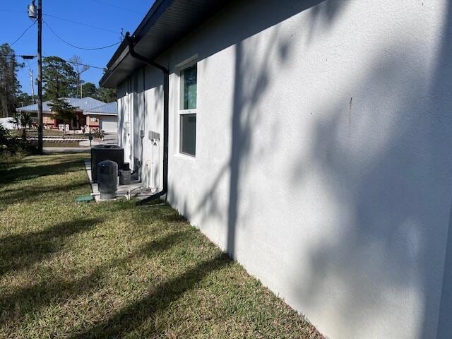 view of home's exterior featuring a yard and stucco siding