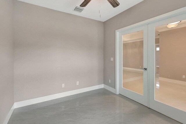 unfurnished room featuring a ceiling fan, concrete floors, visible vents, and baseboards