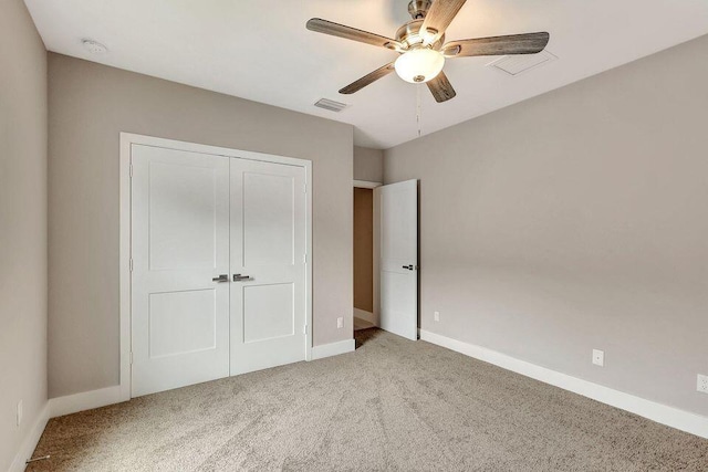 unfurnished bedroom with a closet, carpet flooring, visible vents, and baseboards