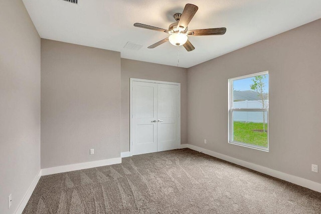 unfurnished bedroom featuring carpet floors and baseboards