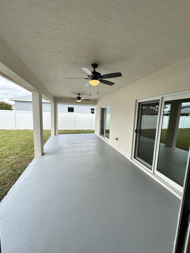 view of patio / terrace with fence and ceiling fan