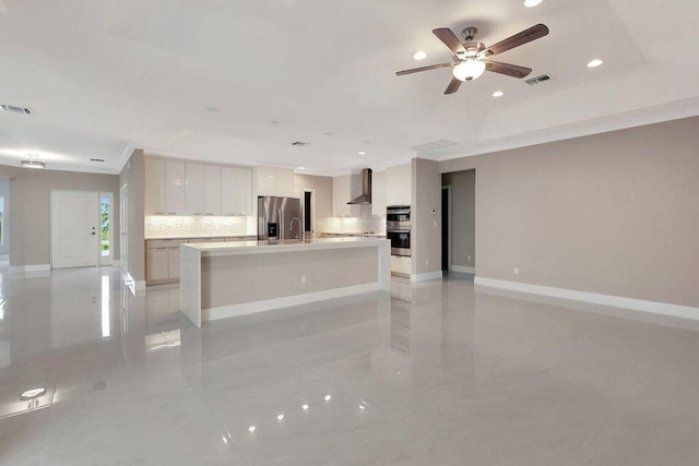 kitchen featuring visible vents, wall chimney exhaust hood, appliances with stainless steel finishes, open floor plan, and backsplash