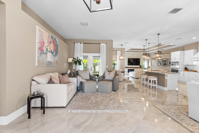 living room featuring marble finish floor, visible vents, french doors, and baseboards