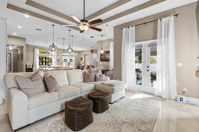 living area featuring baseboards, visible vents, a raised ceiling, a ceiling fan, and recessed lighting