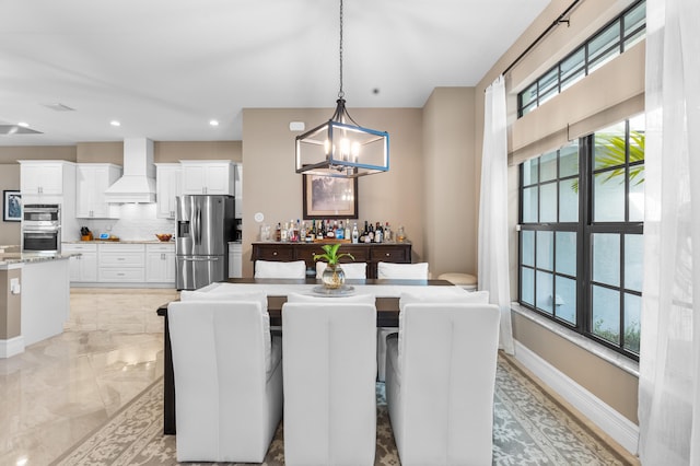 dining room with marble finish floor, recessed lighting, and baseboards