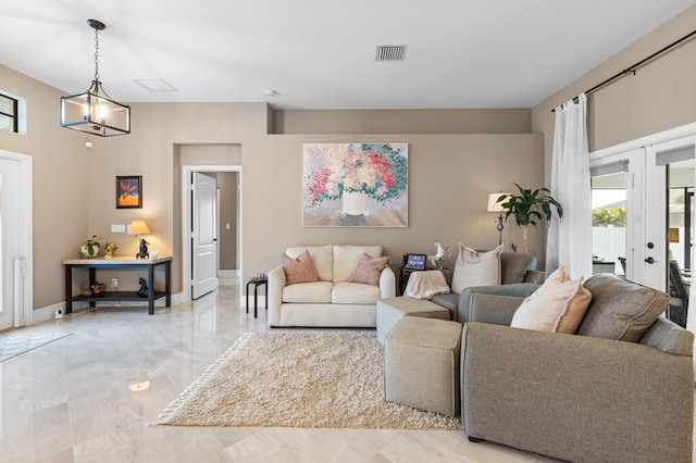 living area featuring french doors, visible vents, marble finish floor, and baseboards