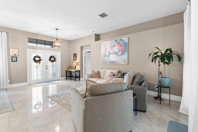 living area with marble finish floor, french doors, visible vents, and baseboards