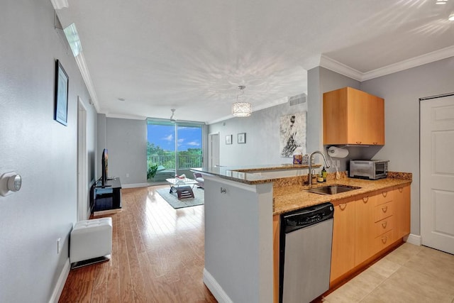 kitchen with a sink, crown molding, a peninsula, and dishwasher