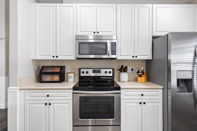 kitchen featuring white cabinetry, appliances with stainless steel finishes, and light countertops