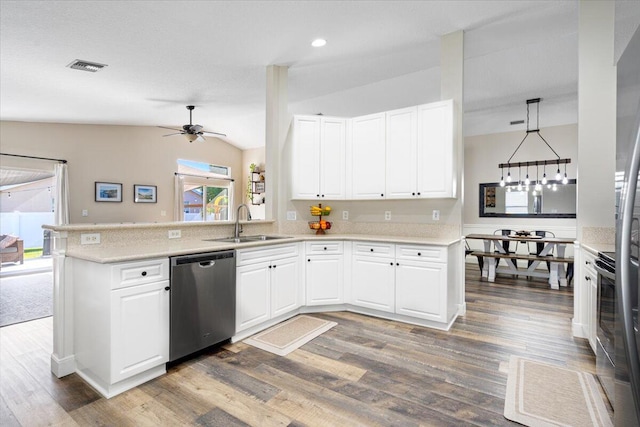 kitchen featuring visible vents, white cabinets, appliances with stainless steel finishes, a peninsula, and a sink