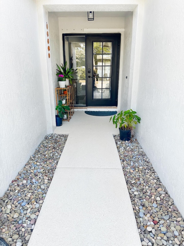 entrance to property featuring stucco siding