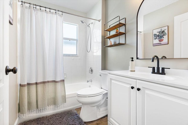 bathroom featuring shower / tub combo, vanity, and toilet