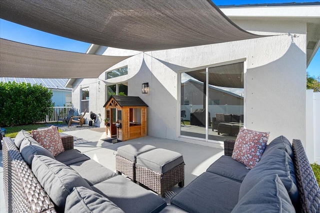 view of patio featuring fence and an outdoor hangout area