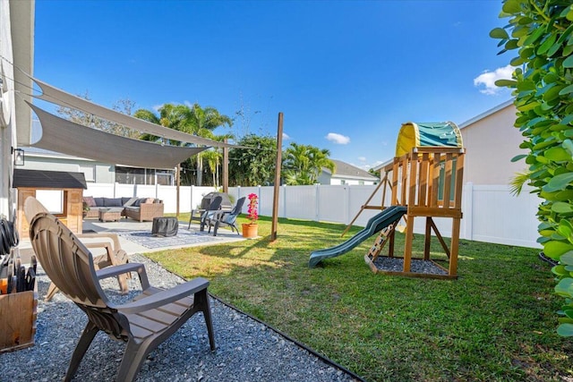 view of playground featuring an outdoor hangout area, a lawn, a patio area, and a fenced backyard