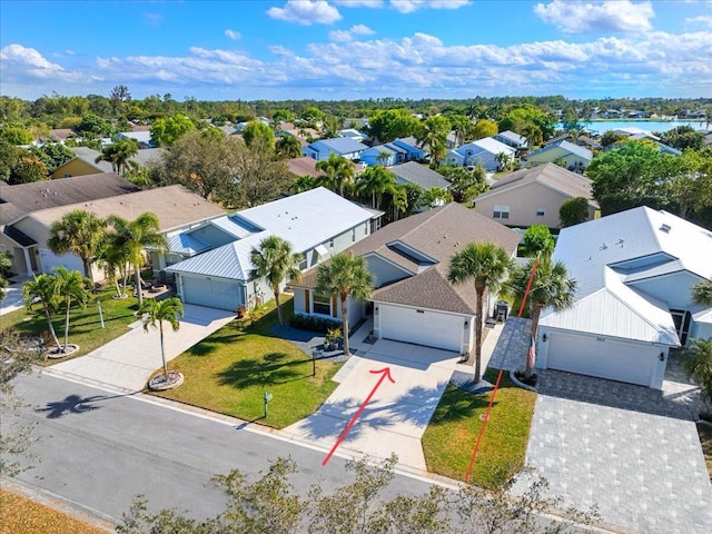 birds eye view of property with a water view and a residential view