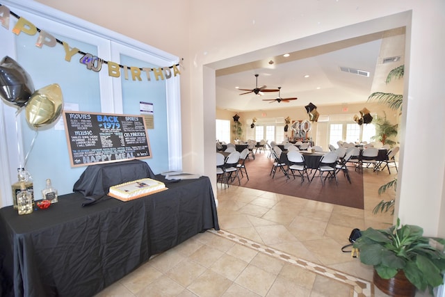 interior space featuring tile patterned flooring, visible vents, a raised ceiling, and recessed lighting