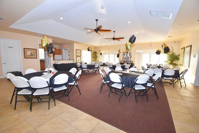 dining area with light tile patterned floors, a tray ceiling, visible vents, and recessed lighting