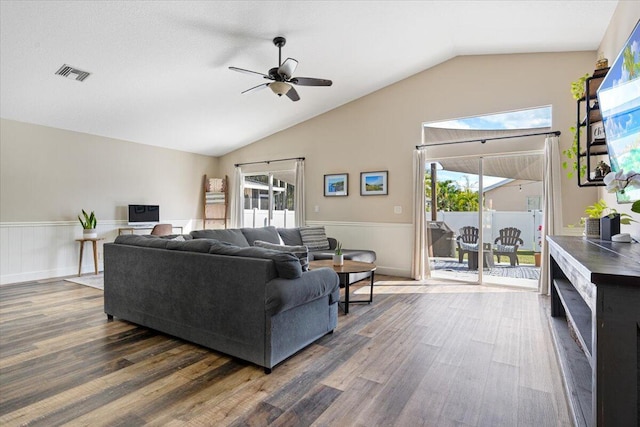 living room with wainscoting, wood finished floors, and visible vents