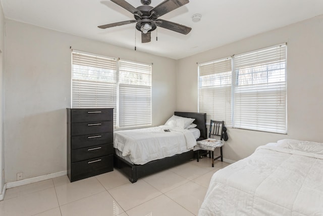 bedroom with a ceiling fan, light tile patterned flooring, and baseboards