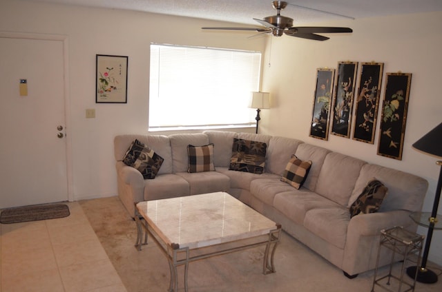 living room featuring light tile patterned floors and a ceiling fan