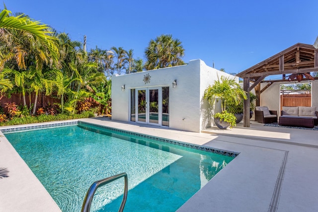 view of swimming pool with a patio area, a fenced backyard, outdoor lounge area, and a gazebo