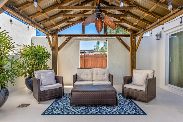 view of patio with a gazebo, outdoor lounge area, and fence