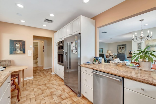 kitchen featuring visible vents, white cabinets, hanging light fixtures, stainless steel appliances, and recessed lighting