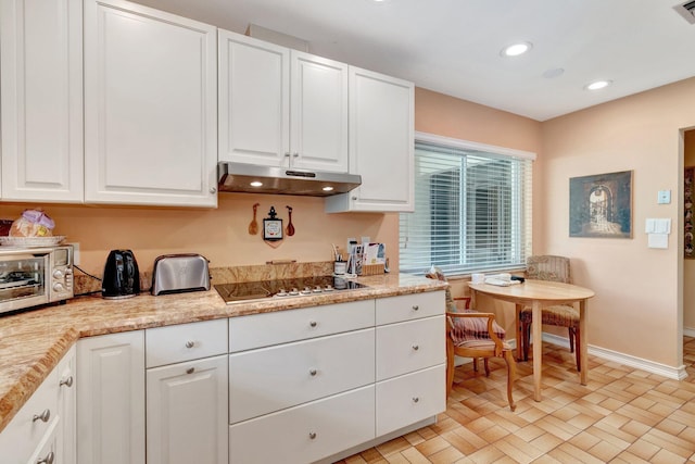 kitchen featuring black electric stovetop, recessed lighting, under cabinet range hood, baseboards, and white cabinets