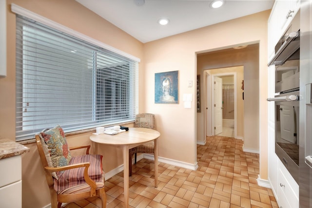 living area with baseboards and recessed lighting