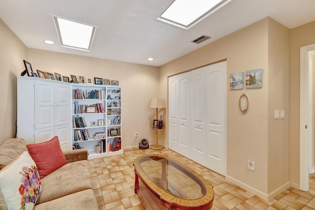 living area with recessed lighting, visible vents, and baseboards