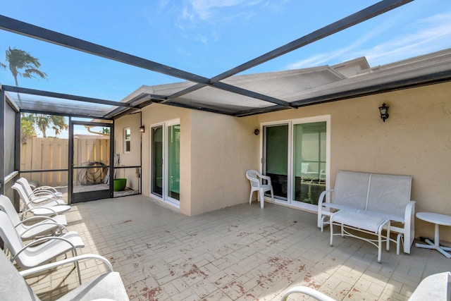 view of patio / terrace with fence and a lanai