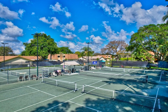 view of tennis court featuring fence