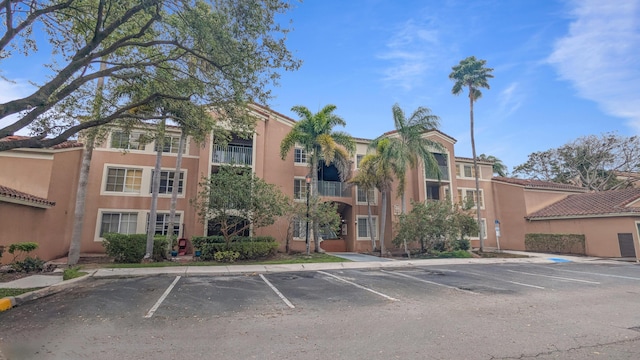 view of building exterior featuring uncovered parking